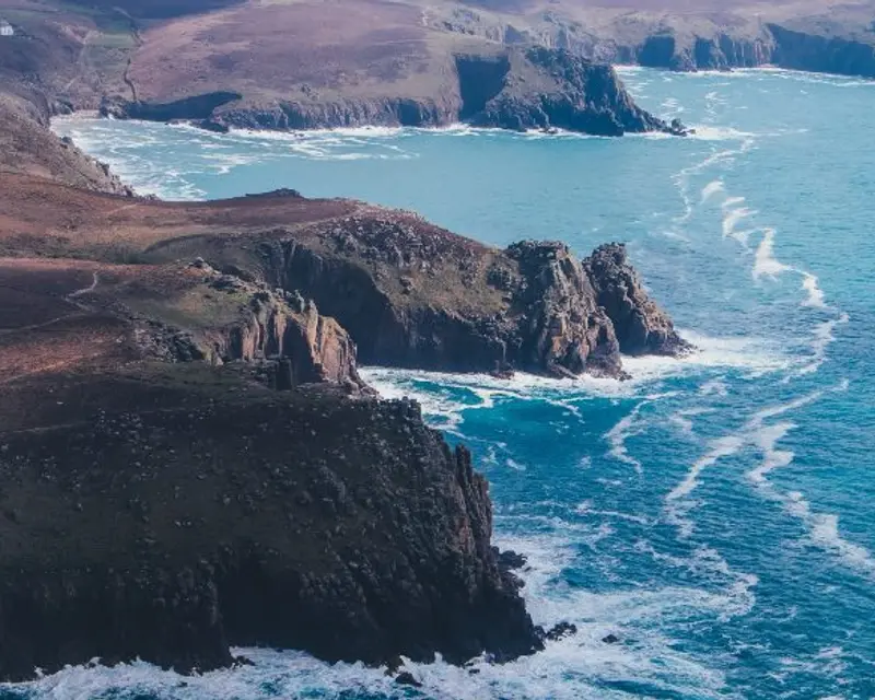 Stunning coastal cliffs meet a vibrant blue sea, showcasing the rugged beauty of the UK’s shoreline. Perfect for exploration!