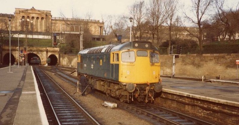 a train carriage waiting outside one of the train stations in Scotland