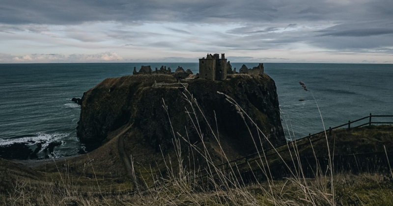 a view of Dunnottar Castle looking magnificent perched on a cliffedge on Scotland’s coast