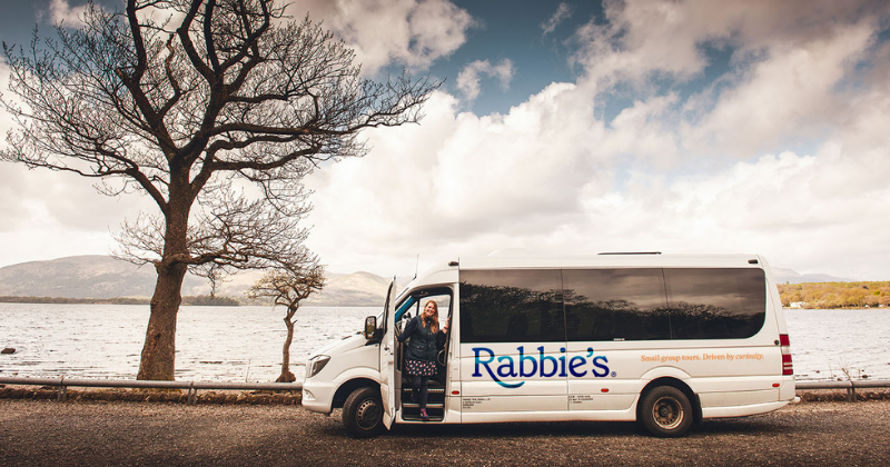 one of the cheapest ways to travel around Scotland is aboard a Rabbie's mini coach