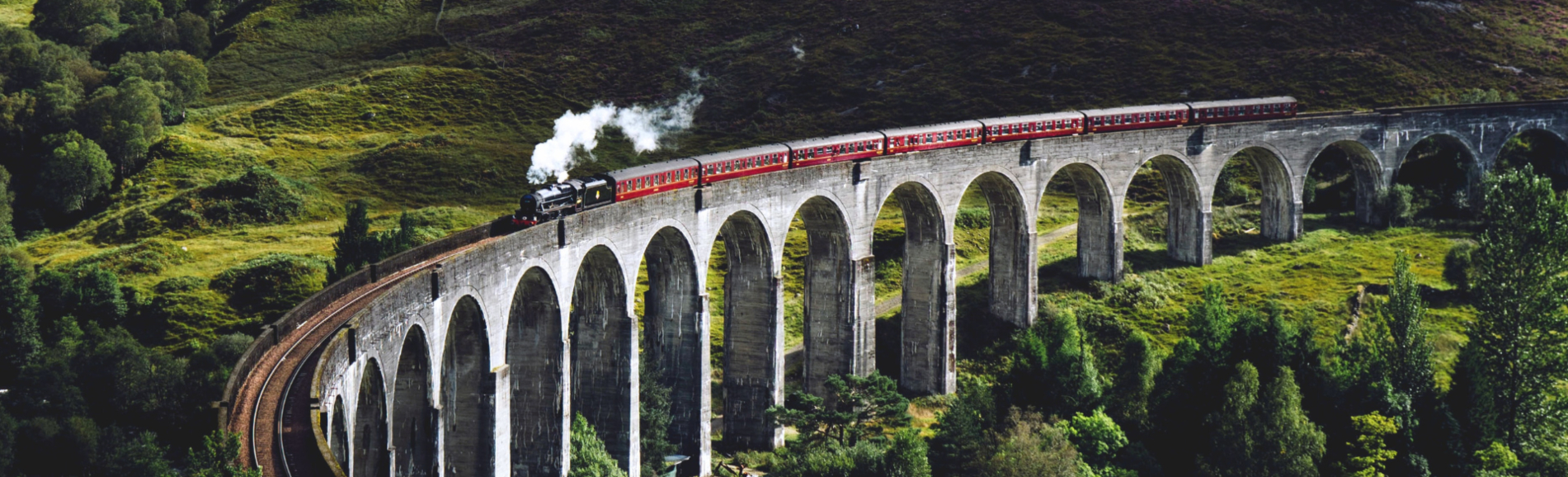 A view of a train travelling along the Glenfinnan Viaduct in Scotland