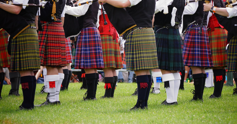 a photo of men wearing family tartans from the waist down