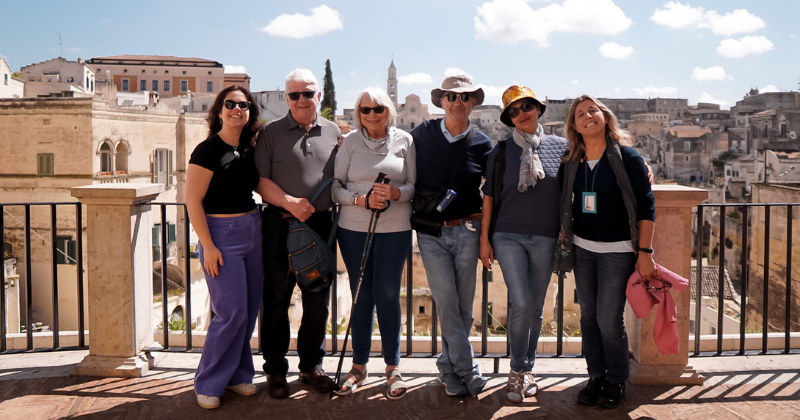 a small-group trip smiling for a photo in Italy