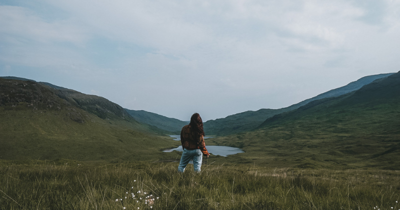 solo traveller standing looking at the view ahead