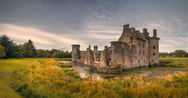 The unique, triangular ruins of caerlaverock castle are one of the amazing sites to see on a visit to Dumfries and Galloway
