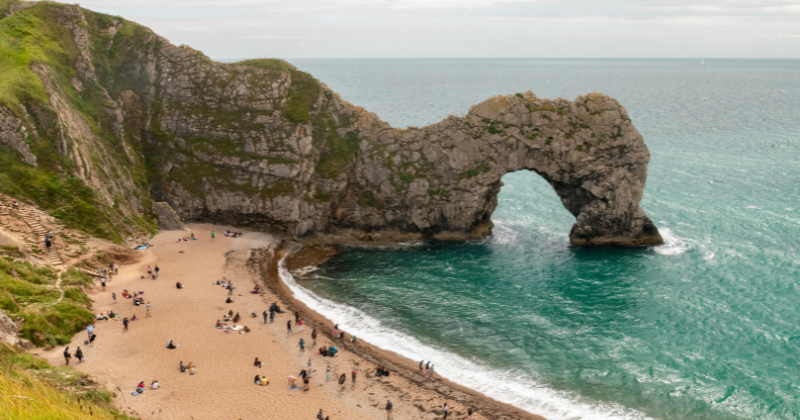 A scenic coastal view of Durdle Door, one of the most iconic natural stone arches in Britain.